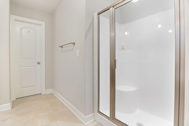 bathroom featuring tile patterned floors and a shower with door