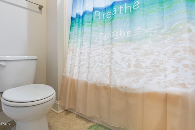 bathroom with toilet and tile patterned flooring