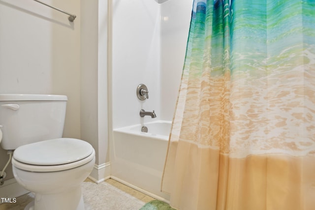 bathroom featuring tile patterned floors, toilet, and shower / bath combo