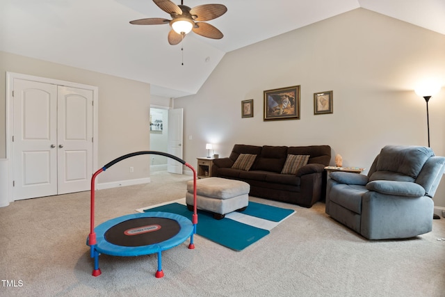 living room featuring ceiling fan, lofted ceiling, and light colored carpet