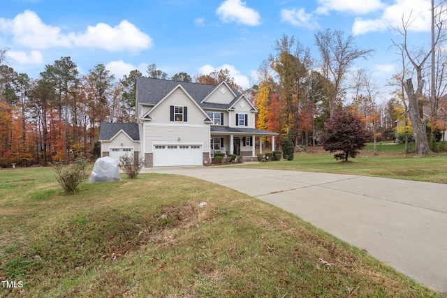 view of front of house with a porch, a garage, and a front yard