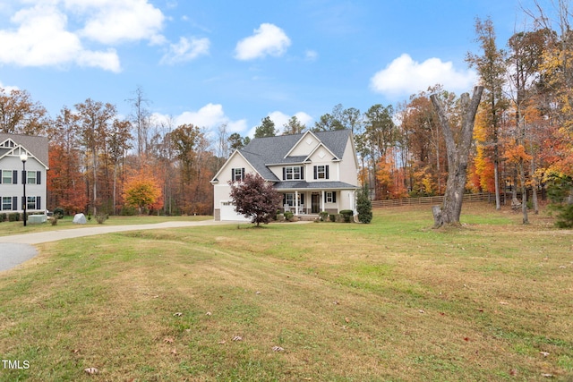 view of property featuring a front lawn and a porch