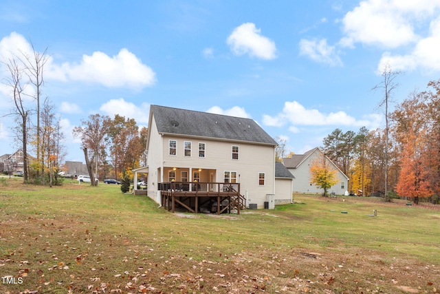 back of house with a yard and a deck