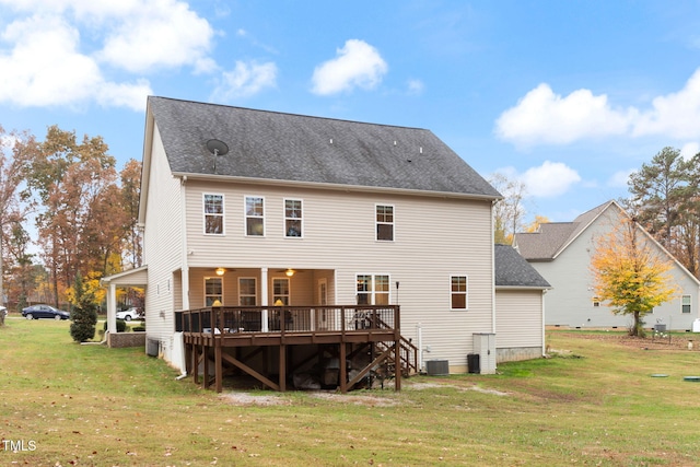 back of house with cooling unit, a wooden deck, and a yard