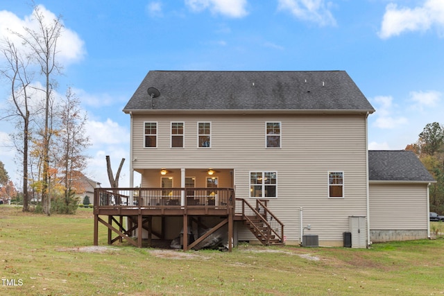 rear view of house with a wooden deck, a yard, and central AC unit