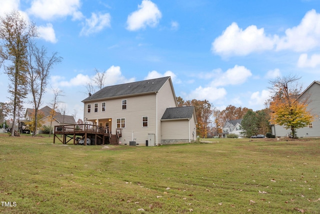 back of house with a yard and a deck