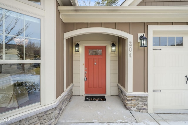 view of exterior entry with a garage