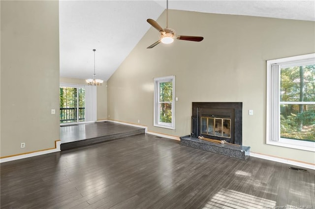 unfurnished living room featuring a high end fireplace, high vaulted ceiling, and a wealth of natural light