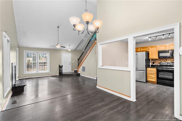 unfurnished living room with dark hardwood / wood-style floors, lofted ceiling, and ceiling fan with notable chandelier