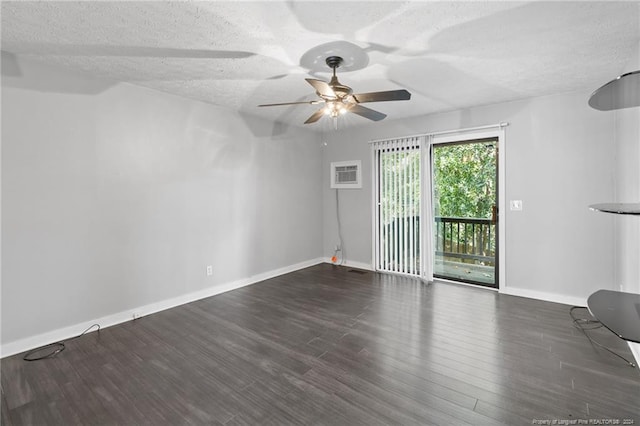 empty room featuring dark hardwood / wood-style flooring, a textured ceiling, and ceiling fan