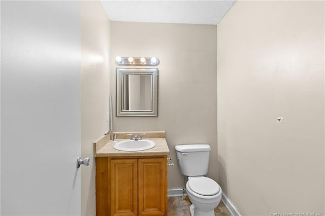 bathroom with tile patterned floors, vanity, and toilet