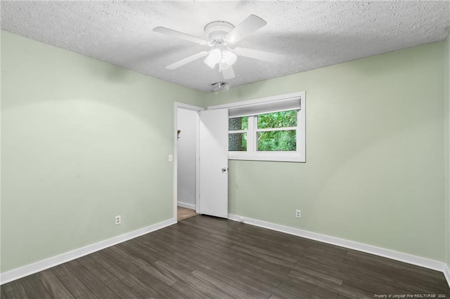 spare room with ceiling fan, dark wood-type flooring, and a textured ceiling