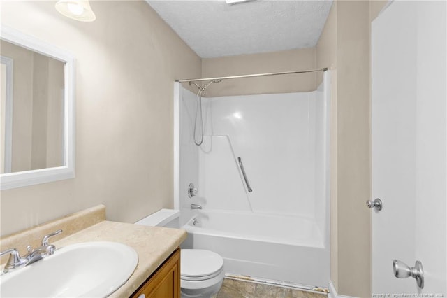 full bathroom with  shower combination, vanity, a textured ceiling, and toilet