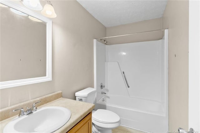 full bathroom with washtub / shower combination, vanity, a textured ceiling, and toilet