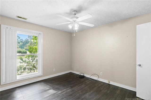 spare room featuring ceiling fan, dark hardwood / wood-style flooring, and a textured ceiling