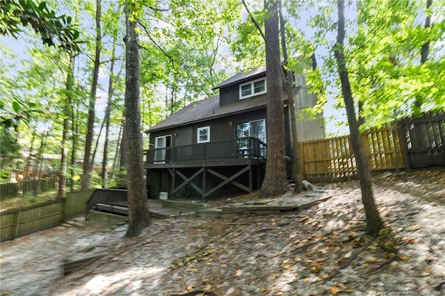 rear view of property featuring a wooden deck