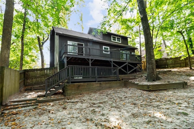 rear view of property featuring a deck