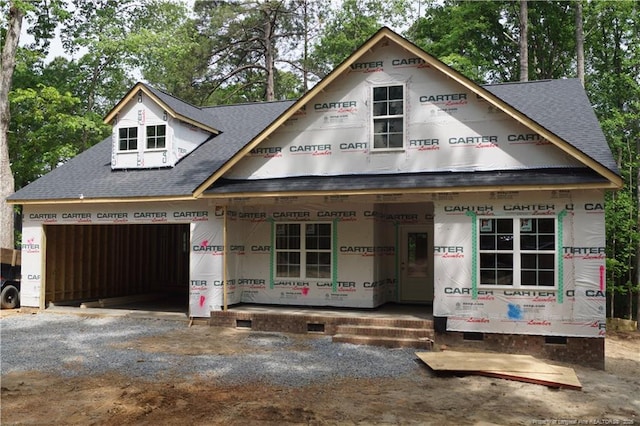 unfinished property with crawl space, roof with shingles, dirt driveway, and a garage