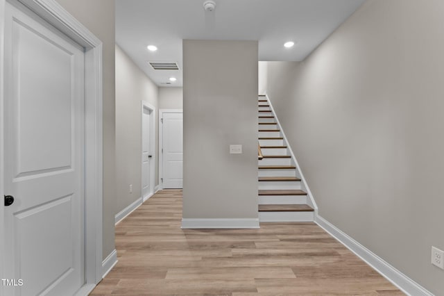 stairway with hardwood / wood-style flooring