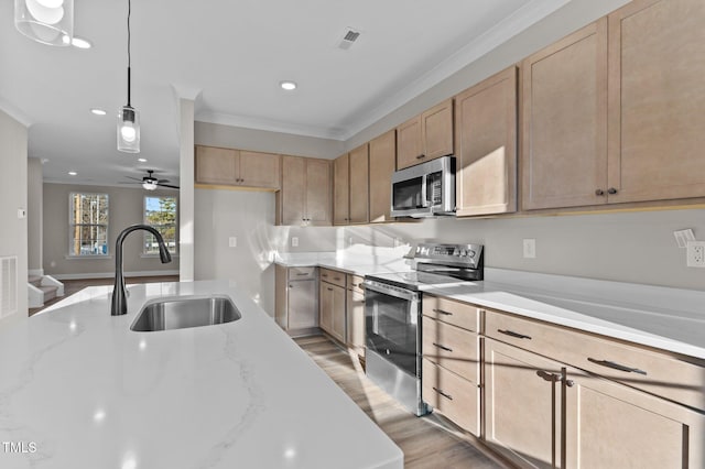 kitchen featuring ceiling fan, sink, light brown cabinets, stainless steel appliances, and pendant lighting