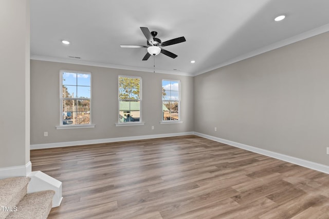 unfurnished room with ceiling fan, ornamental molding, and light wood-type flooring