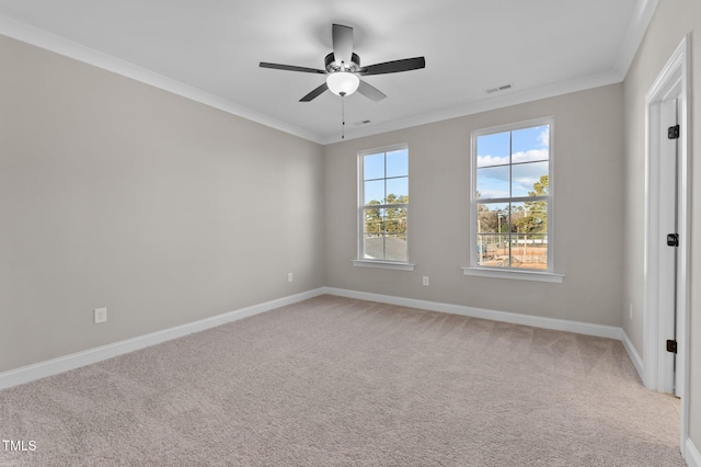 carpeted empty room featuring ceiling fan and crown molding