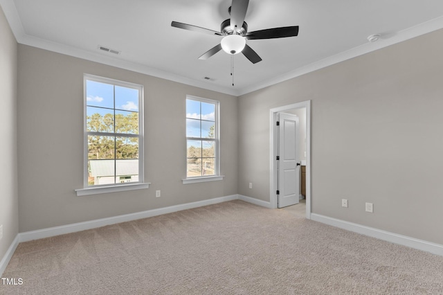 unfurnished room with light carpet, ceiling fan, and crown molding