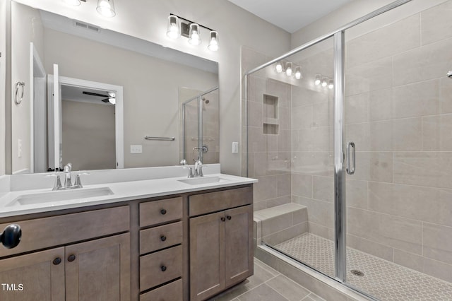 bathroom featuring ceiling fan, tile patterned flooring, vanity, and a shower with door