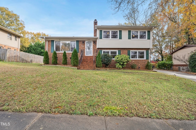 tri-level home with a front yard