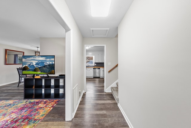 hall with dark hardwood / wood-style flooring and sink