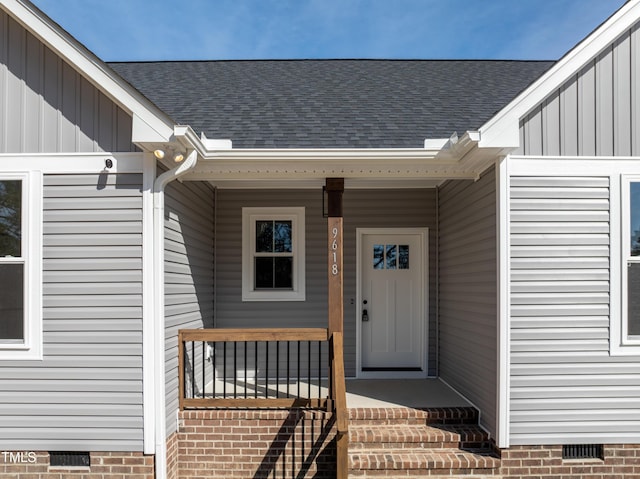 doorway to property featuring board and batten siding, crawl space, and a shingled roof