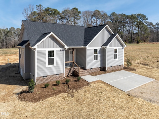 modern inspired farmhouse featuring roof with shingles, crawl space, board and batten siding, and driveway