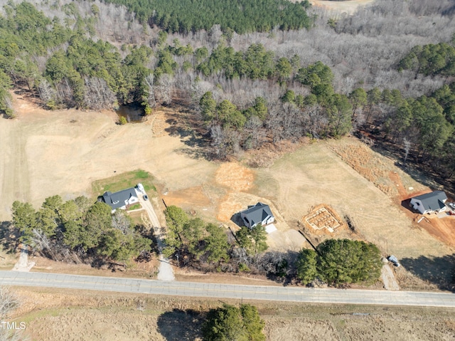 birds eye view of property with a view of trees