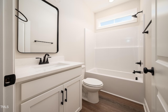 bathroom featuring shower / bathing tub combination, vanity, toilet, and wood finished floors