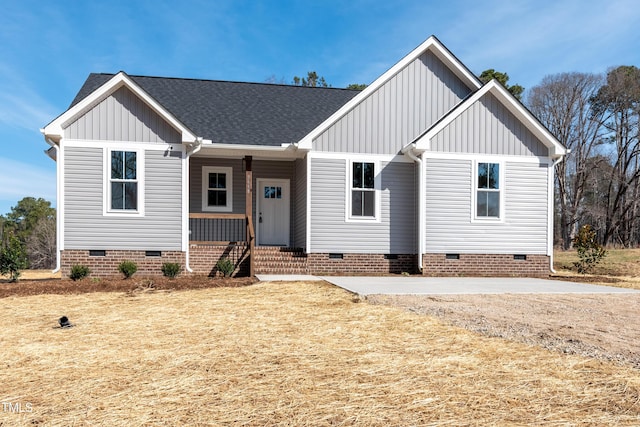 view of front of property with a shingled roof, crawl space, and board and batten siding