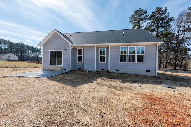 rear view of property with crawl space, a patio area, and a shingled roof