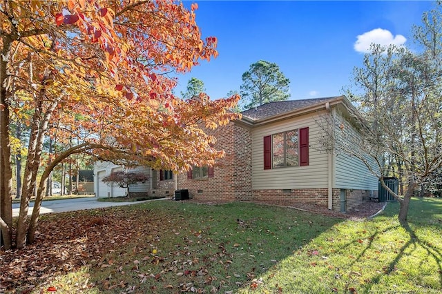 view of front of home with a garage and a front lawn