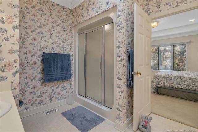 bathroom with ornamental molding and walk in shower