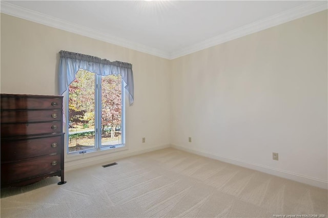 empty room with light carpet and crown molding