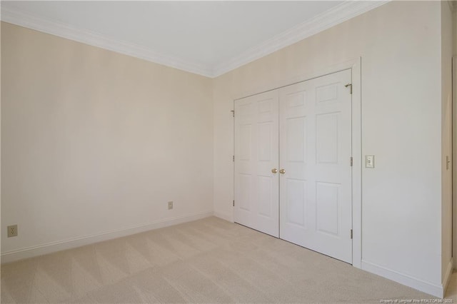 unfurnished bedroom with light carpet and crown molding