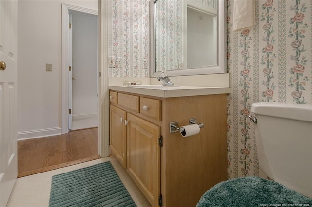 bathroom featuring vanity and toilet