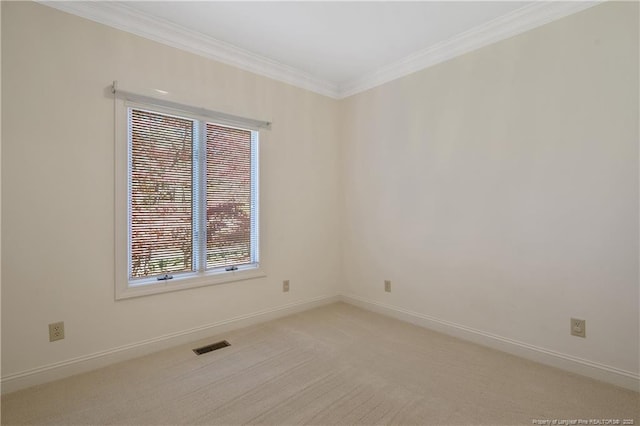 unfurnished room featuring plenty of natural light, light colored carpet, and ornamental molding