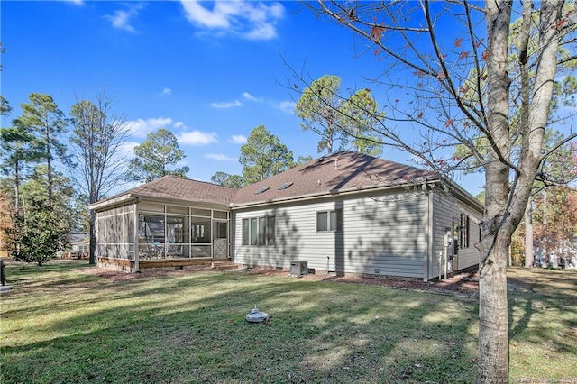 rear view of house featuring a lawn, cooling unit, and a sunroom