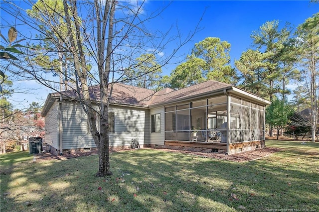 back of house featuring a yard and a sunroom