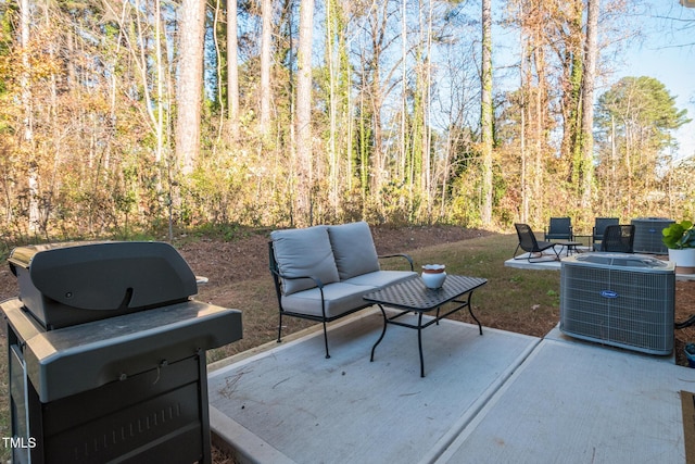 view of patio / terrace featuring a grill, cooling unit, and an outdoor hangout area