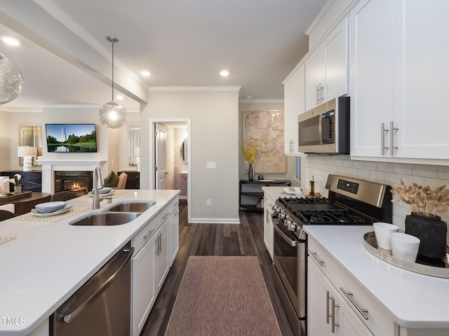 kitchen with a kitchen island with sink, sink, white cabinets, and stainless steel appliances