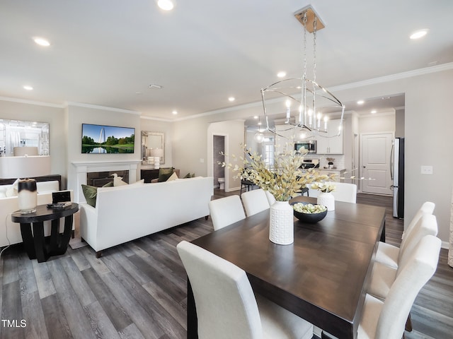 dining space with a notable chandelier, dark hardwood / wood-style floors, and ornamental molding