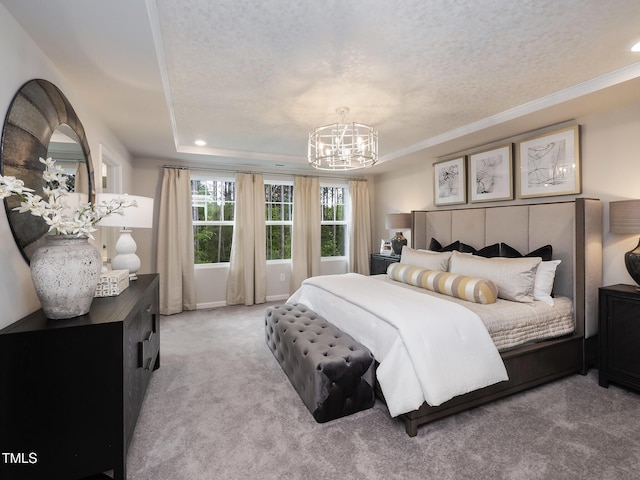 bedroom featuring light carpet, a chandelier, a textured ceiling, and ornamental molding