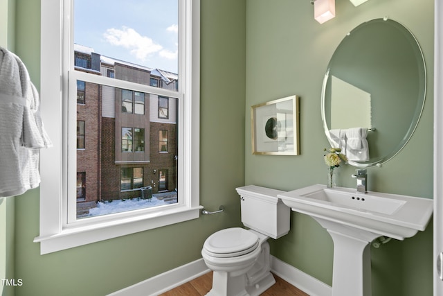 bathroom featuring hardwood / wood-style flooring and toilet