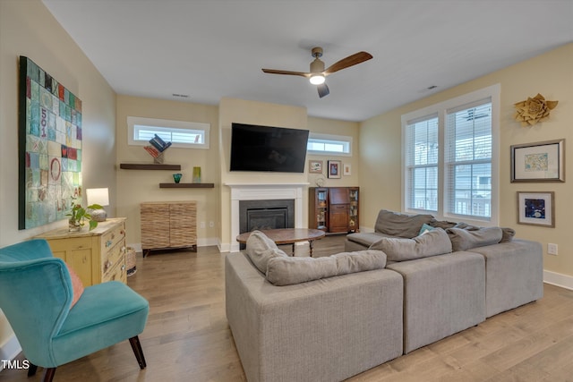 living room with ceiling fan and light wood-type flooring